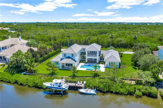 a aerial view of a house with pool lake view and mountain view