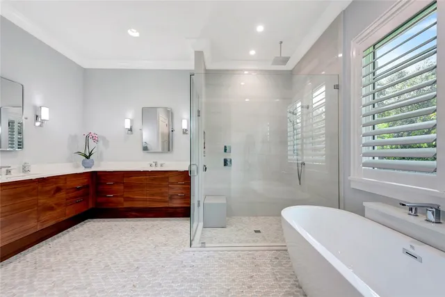 a bathroom with a bathtub shower and sink