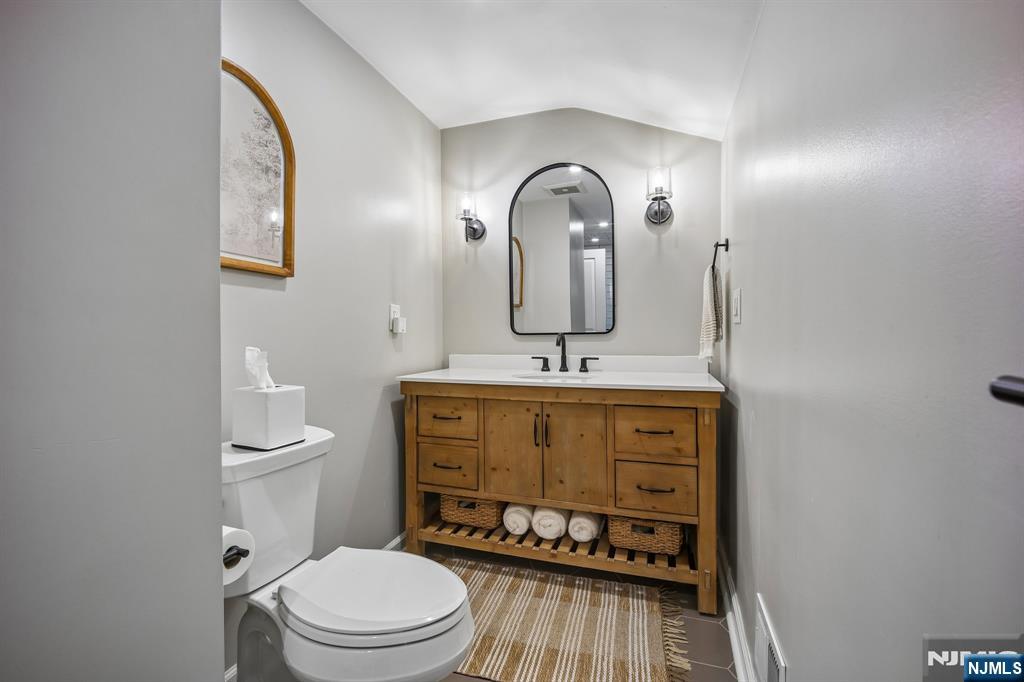 23 Andover Place Bloomfield, NJ 07003 - Photo 24 of 42 a bathroom with a toilet a sink and mirror