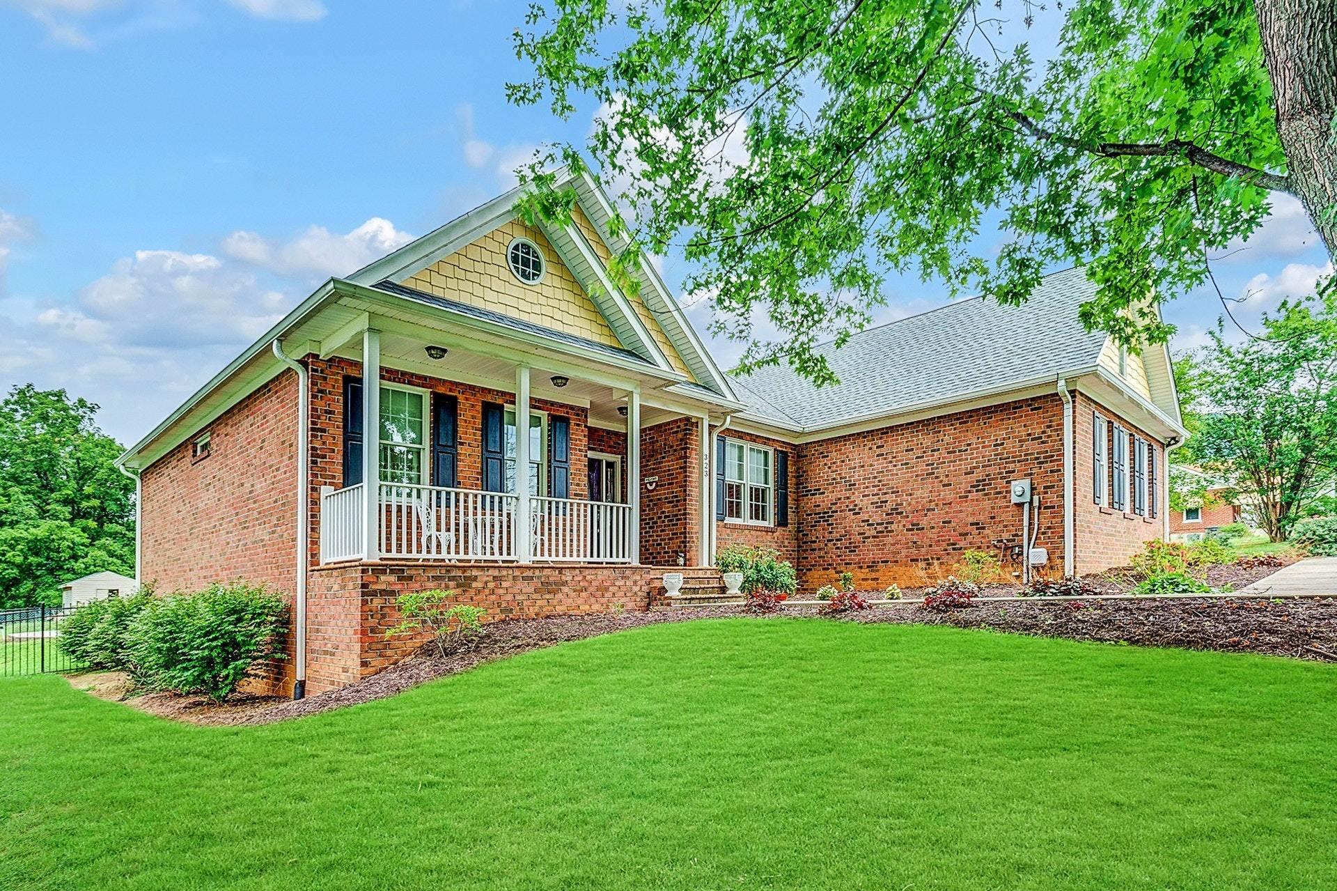 323 Turner Road Salem, VA 24153 - Photo 2 of 37 a front view of a house with a garden and trees