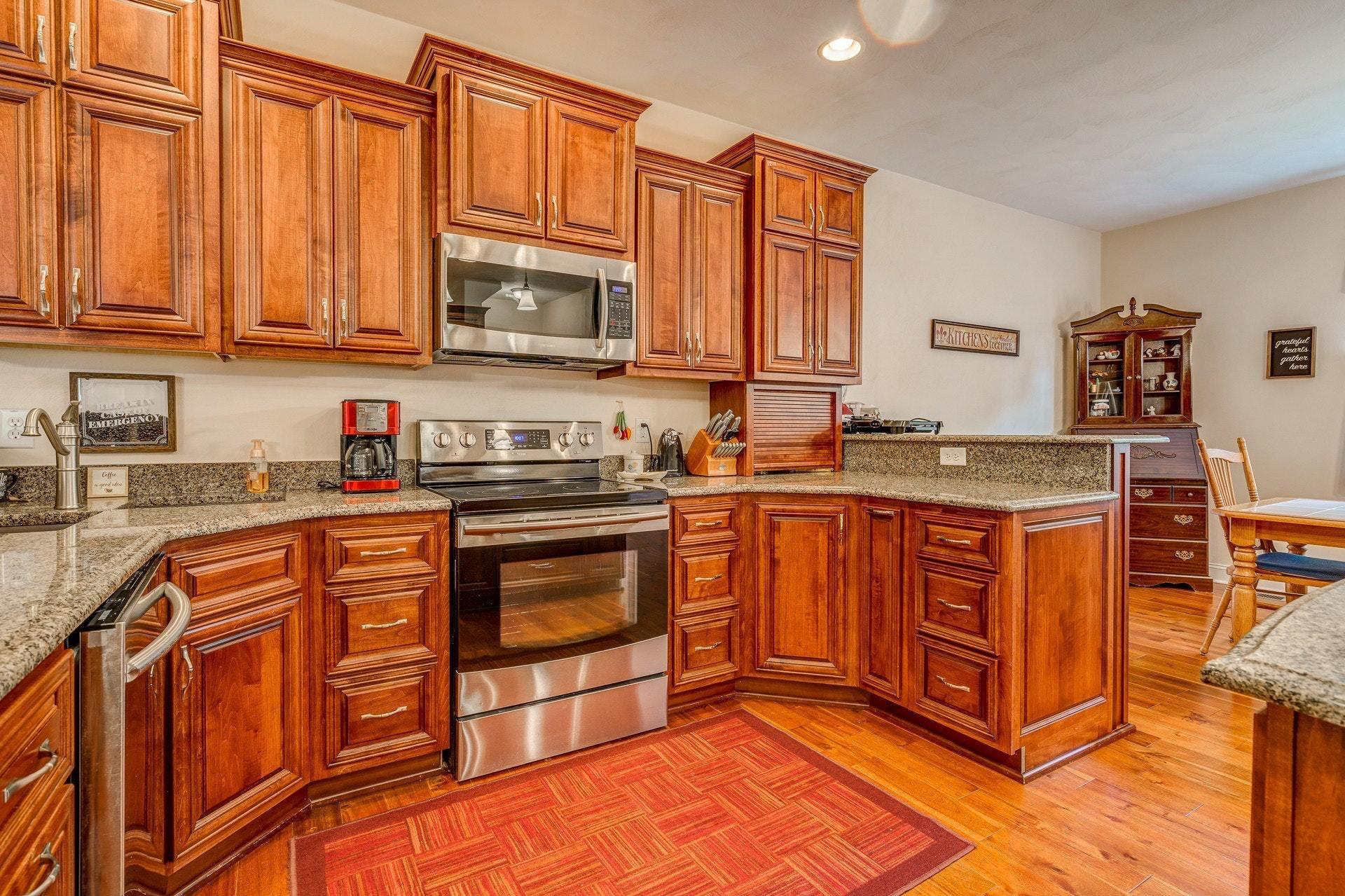 323 Turner Road Salem, VA 24153 - Photo 11 of 37 a kitchen with stainless steel appliances granite countertop a stove top oven a sink dishwasher and cabinets with wooden floor