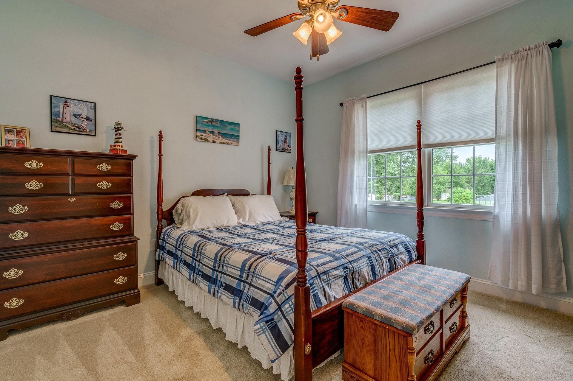 323 Turner Road Salem, VA 24153 - Photo 18 of 37 a bedroom with a bed and a chandelier