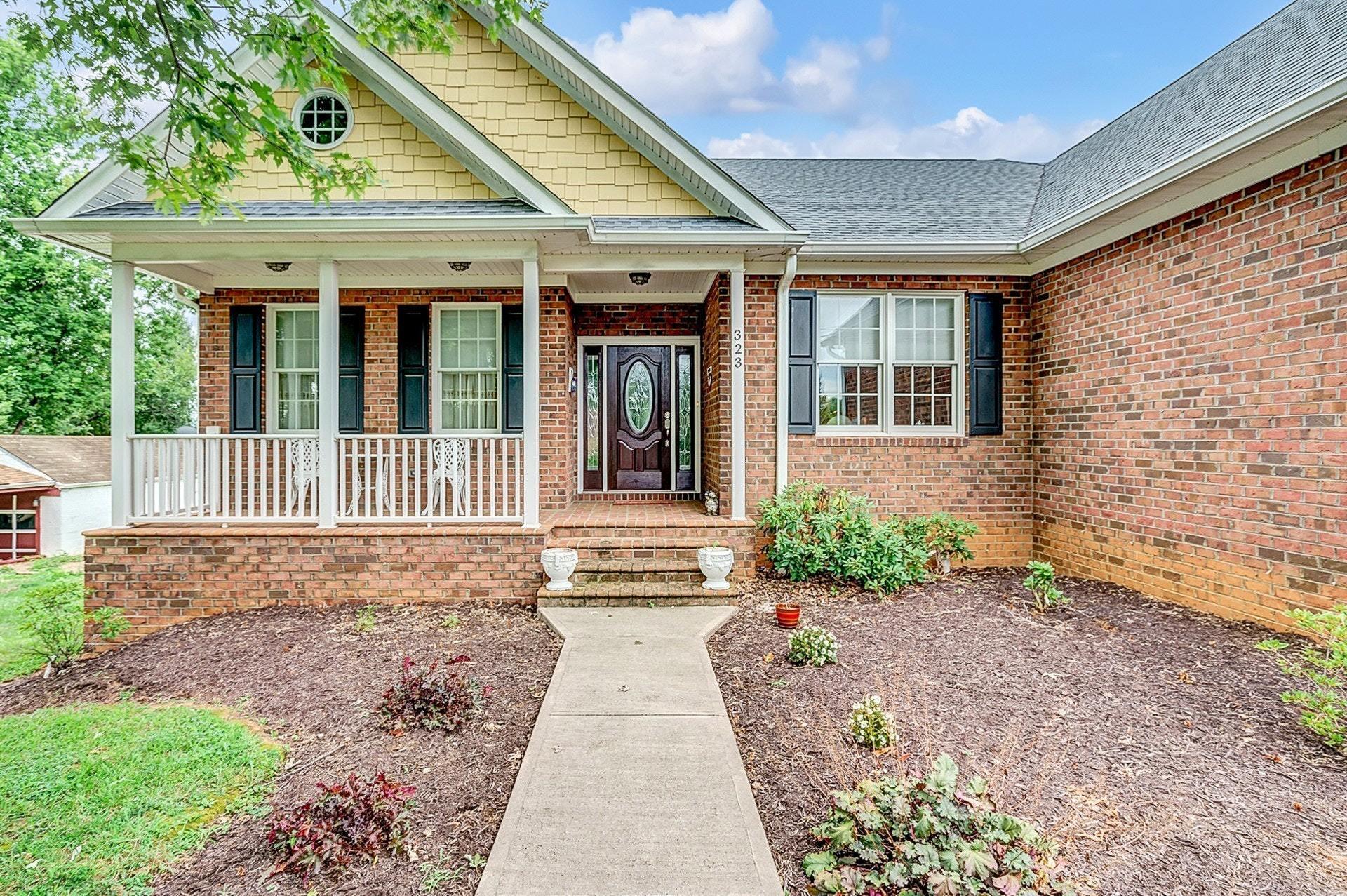 323 Turner Road Salem, VA 24153 - Photo 3 of 37 a front view of a house with a yard and potted plants