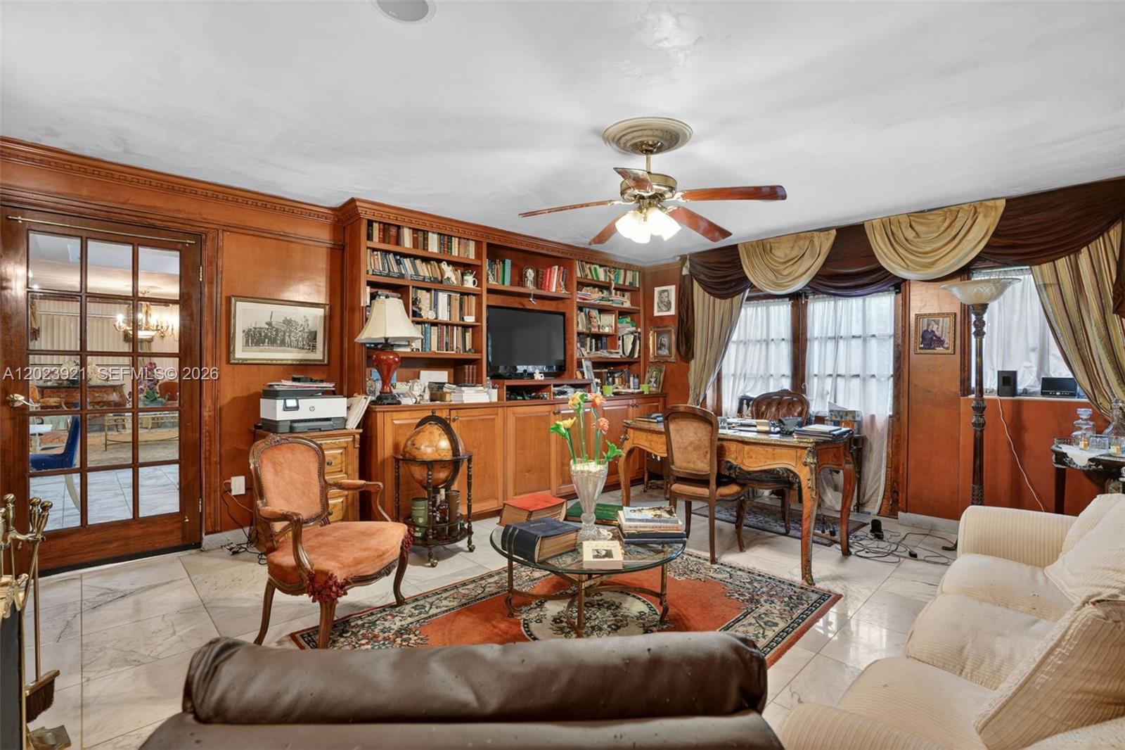 8461 Southwest 68th St Road Miami, FL 33143 - Photo 46 of 65 a living room with furniture a fireplace and a large window