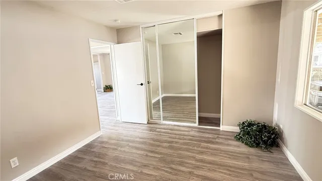 a view of entryway with wooden floor and front door