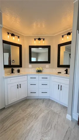 a view of two flat screen tv and cabinets