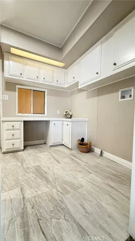 a view of a kitchen with a sink and cabinets