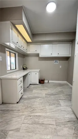 a view of a kitchen with stainless steel appliances granite countertop a sink and cabinets