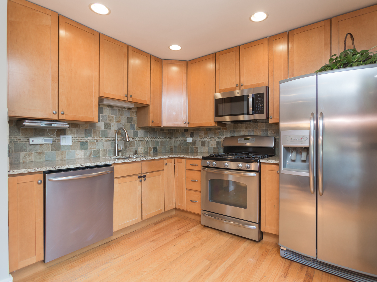 398 Rodenburg Road Roselle, IL 60172 - Photo 13 of 43 a kitchen with stainless steel appliances granite countertop a stove a sink and a microwave