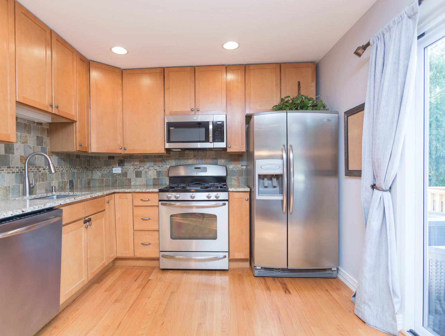 398 Rodenburg Road Roselle, IL 60172 - Photo 14 of 43 a kitchen with stainless steel appliances granite countertop a refrigerator sink and microwave