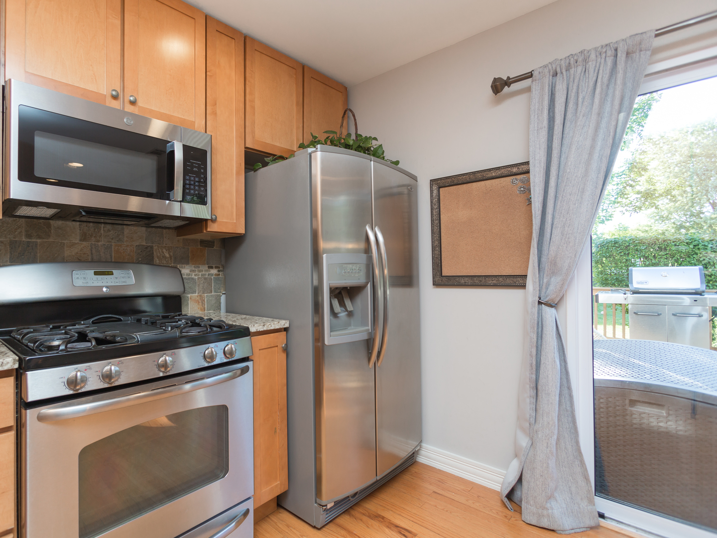 398 Rodenburg Road Roselle, IL 60172 - Photo 16 of 43 a kitchen with stainless steel appliances granite countertop a refrigerator microwave and sink