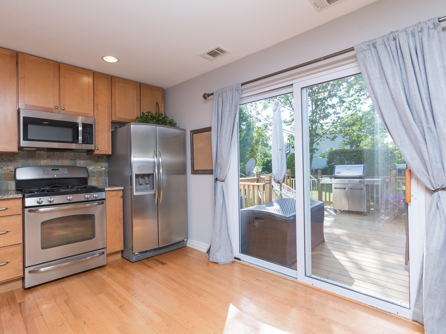 398 Rodenburg Road Roselle, IL 60172 - Photo 18 of 43 a kitchen with stainless steel appliances granite countertop a refrigerator and a stove