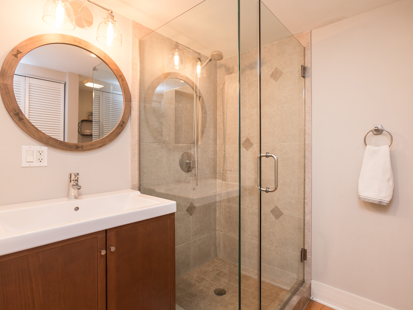 398 Rodenburg Road Roselle, IL 60172 - Photo 20 of 43 a bathroom with a sink a mirror a vanity and shower