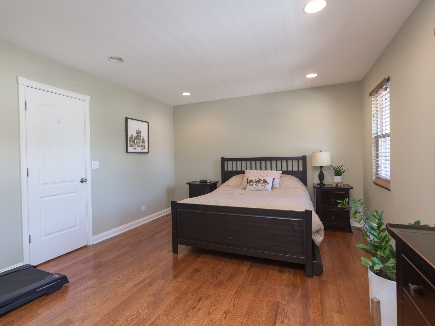 398 Rodenburg Road Roselle, IL 60172 - Photo 26 of 43 a spacious bedroom with a bed and wooden floor