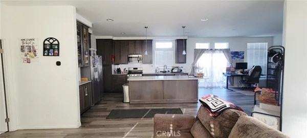 a view of kitchen with refrigerator and window
