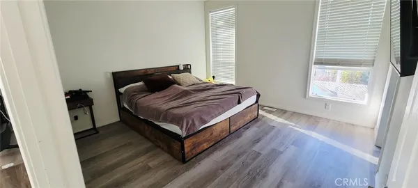 a bedroom with a bed and window