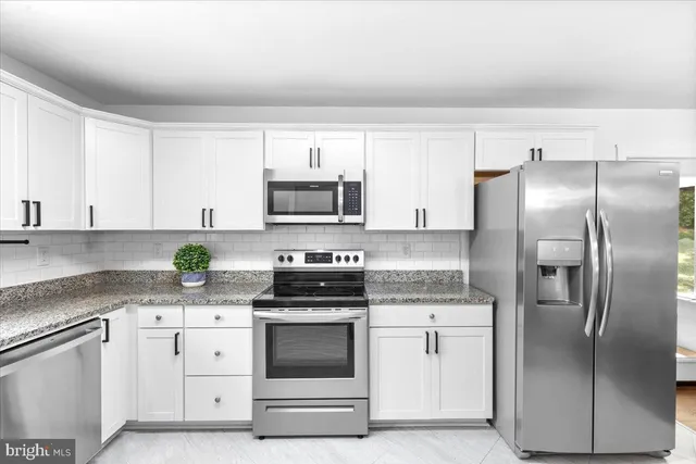 a kitchen with a sink a stove and a window