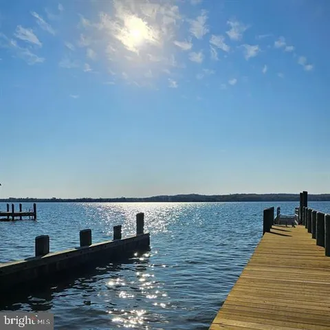 a view of roof deck with two chairs and a table