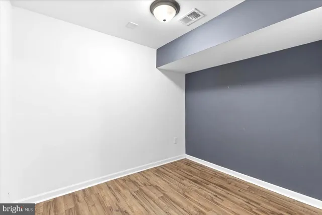 a living room with furniture a flat screen tv and a large window