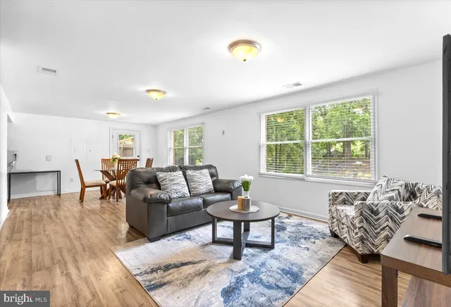 a living room with furniture and wooden floor