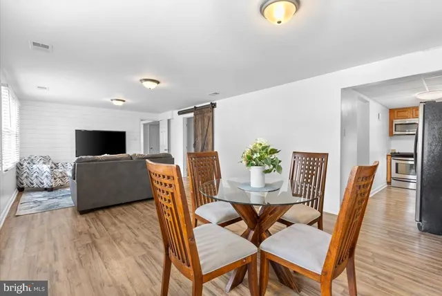 a kitchen with stainless steel appliances granite countertop a sink a stove and a microwave