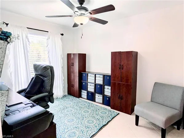 a living room with furniture a rug and a window
