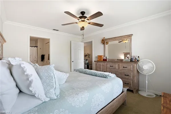 a bedroom with a bed and ceiling fan