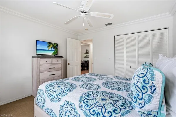 a bedroom with a bed and a television