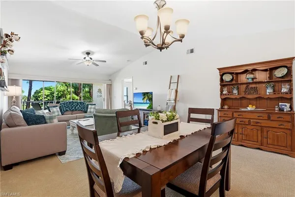 a view of a dining room with furniture window and outside view