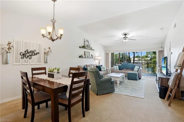 a view of a dining room with furniture wooden floor and chandelier