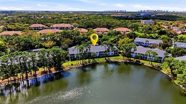 an aerial view of residential houses with outdoor space and swimming pool