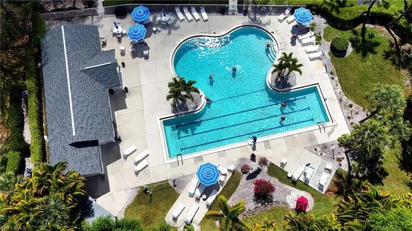 an aerial view of a house swimming pool and outdoor seating