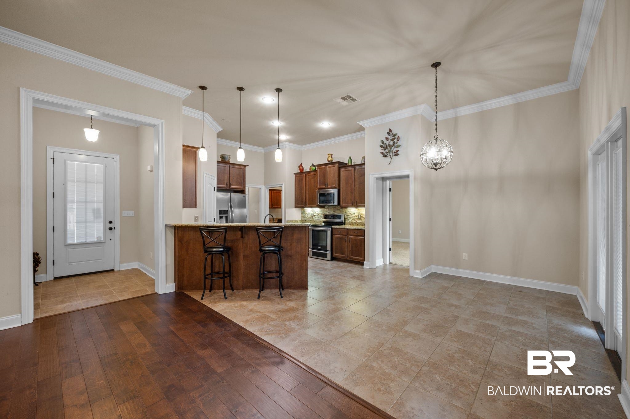 1085 Destin Avenue Foley, AL 36535 - Photo 4 of 35 Kitchen featuring decorative light fixtures, stainless steel appliances, kitchen peninsula, and a kitchen bar