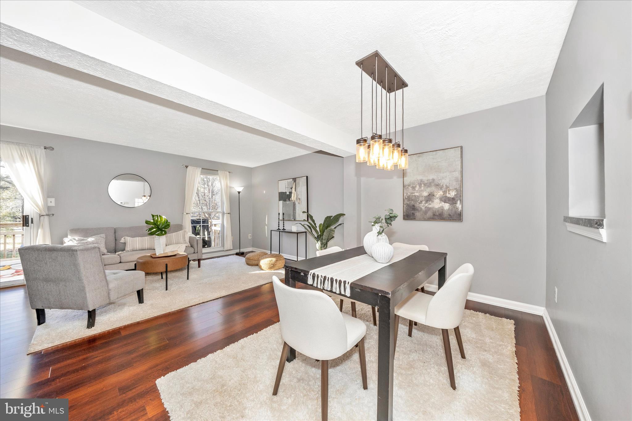 1511 Beverly Court Frederick, MD 21701 - Photo 13 of 72 a living room with furniture a chandelier and a dining room