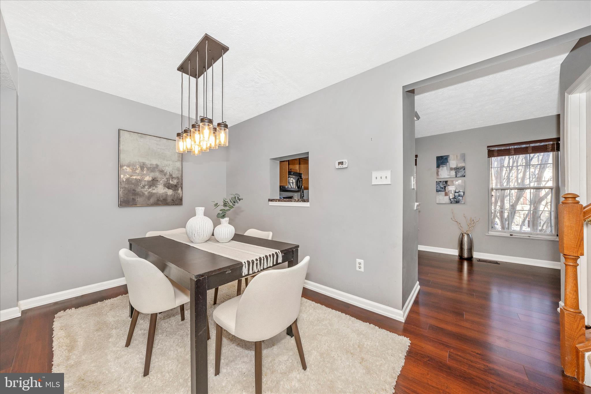 1511 Beverly Court Frederick, MD 21701 - Photo 14 of 72 a dining room with wooden floor a chandelier a wooden table and chairs