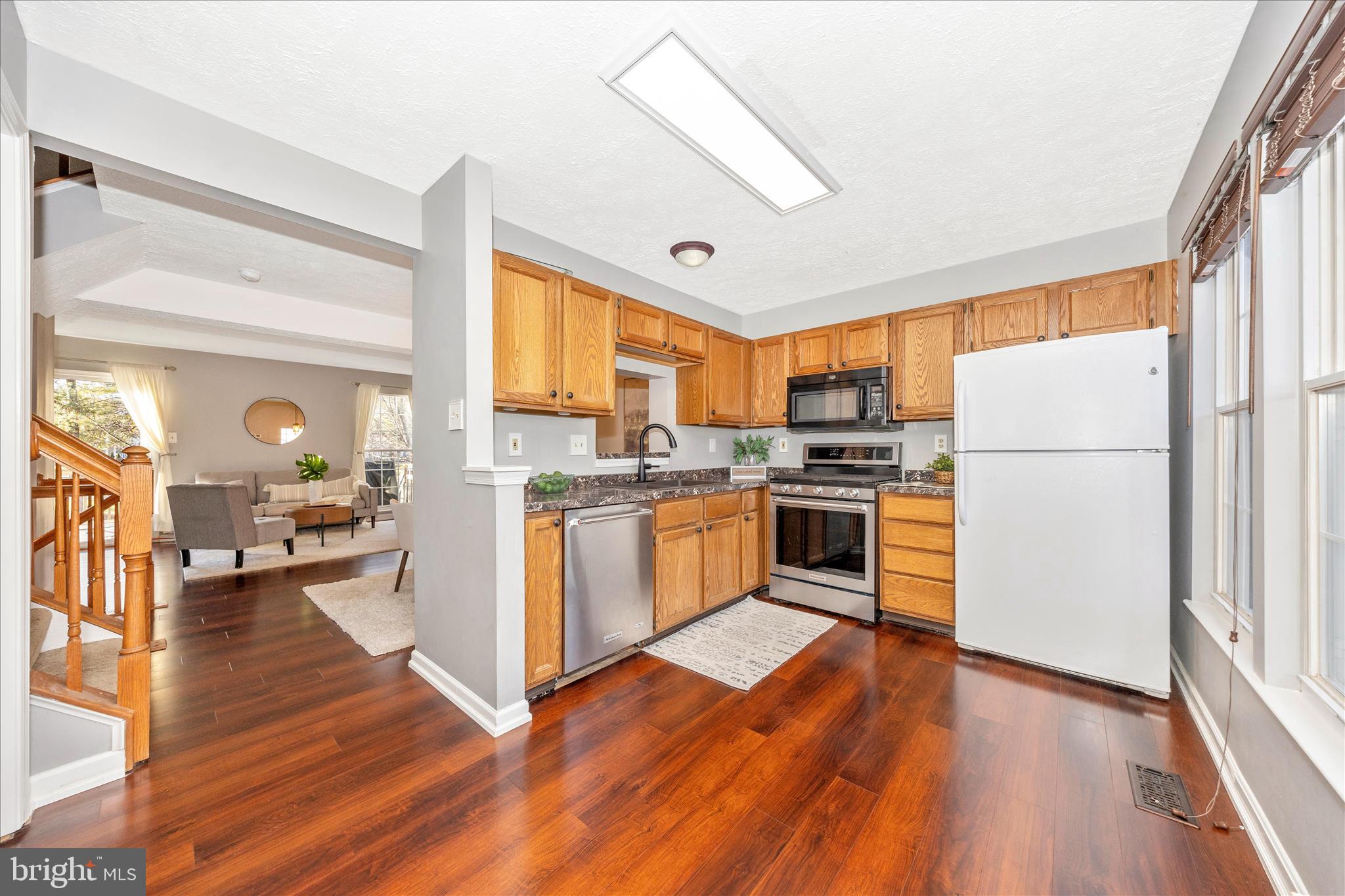 1511 Beverly Court Frederick, MD 21701 - Photo 19 of 72 a kitchen with wooden floors and white stainless steel appliances