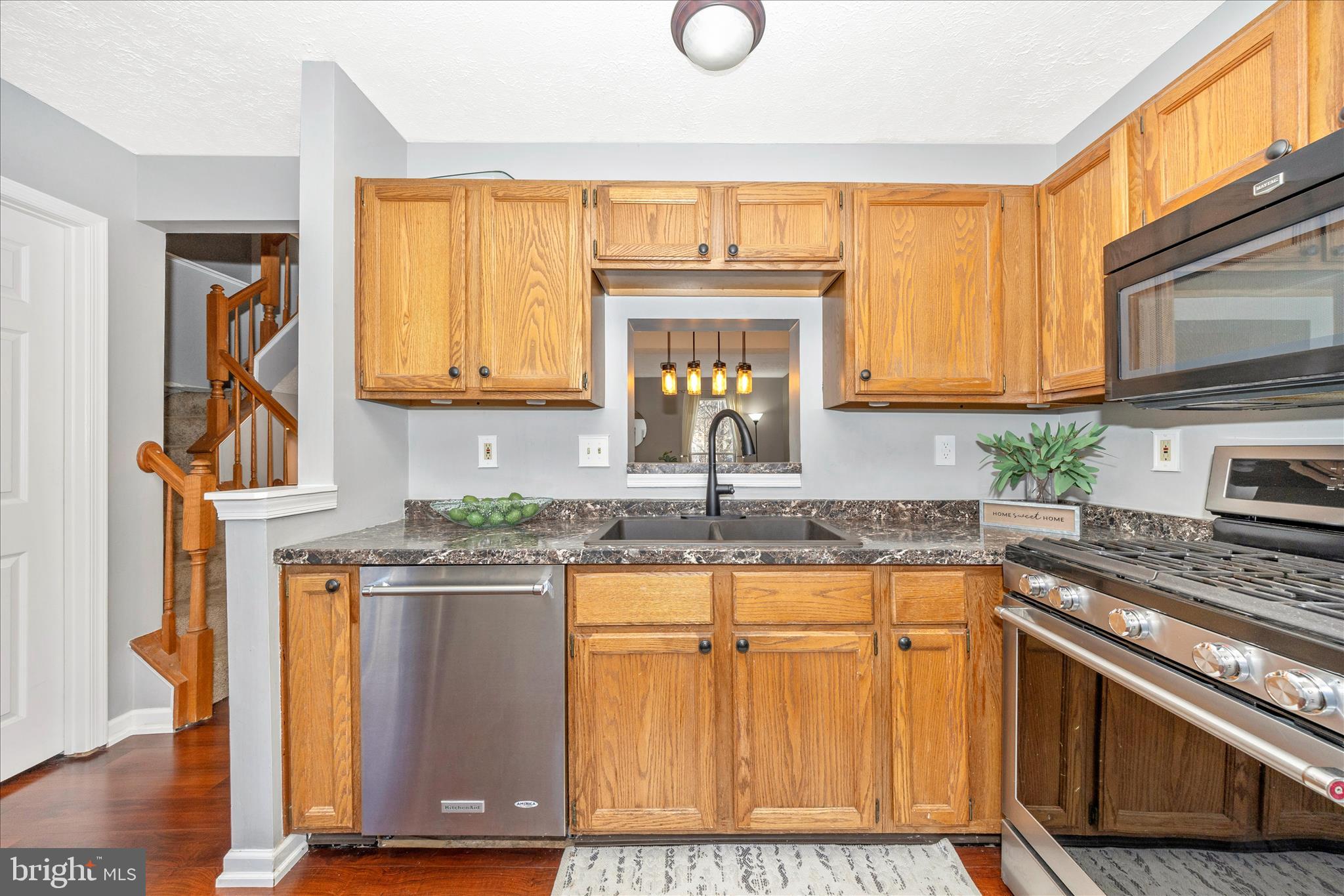 1511 Beverly Court Frederick, MD 21701 - Photo 21 of 72 a kitchen with stainless steel appliances granite countertop a stove a sink and a microwave