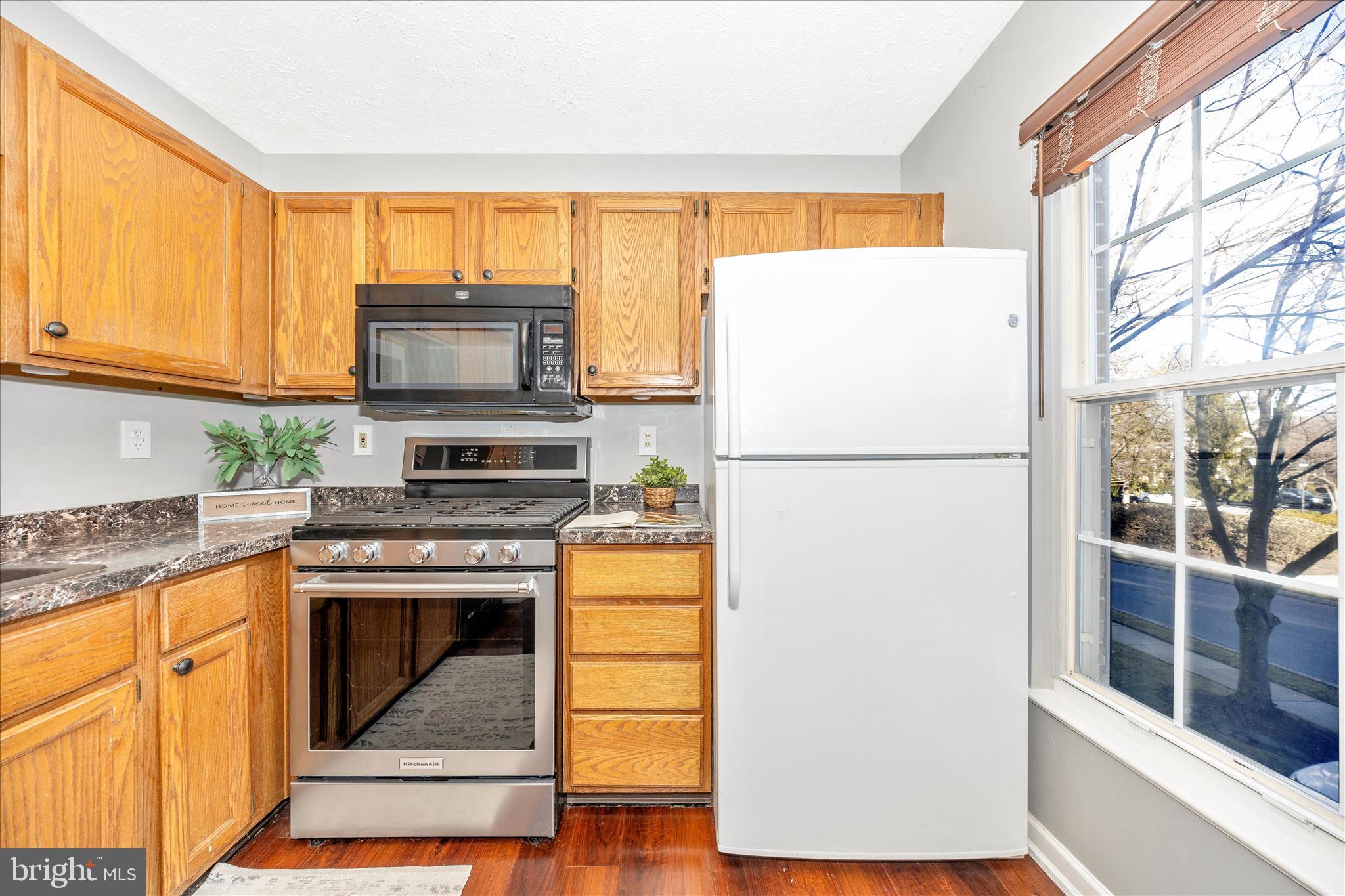 1511 Beverly Court Frederick, MD 21701 - Photo 22 of 72 a kitchen with stainless steel appliances granite countertop a refrigerator a stove a sink a microwave and cabinets