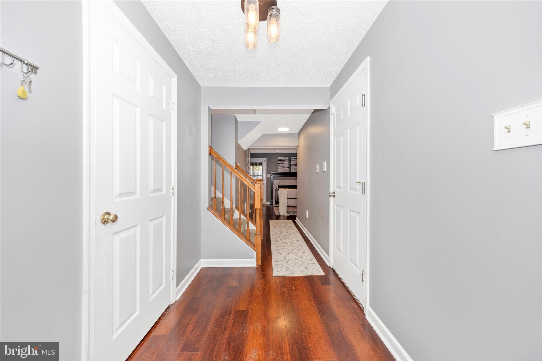 1511 Beverly Court Frederick, MD 21701 - Photo 3 of 72 a view of a hallway with wooden floor and staircase