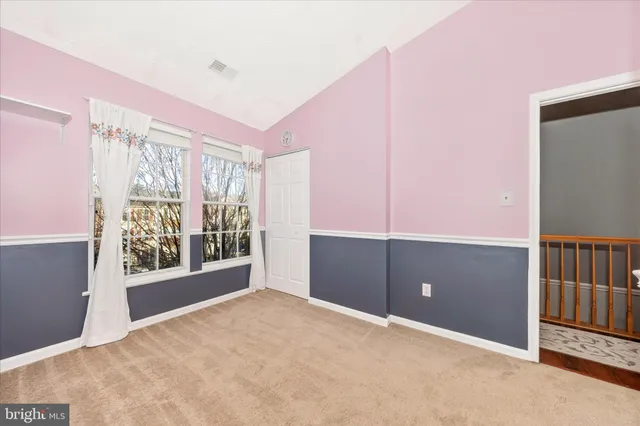 a view of a porch with a table and chairs and floor to ceiling window