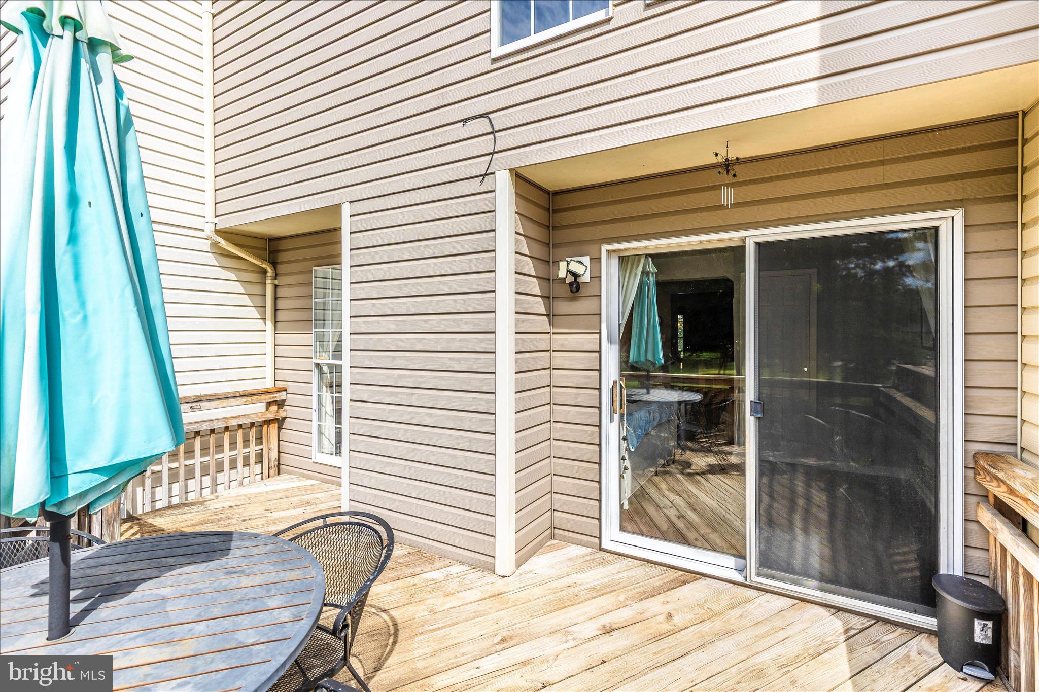 1511 Beverly Court Frederick, MD 21701 - Photo 39 of 72 a view of a porch with a table and chairs and floor to ceiling window
