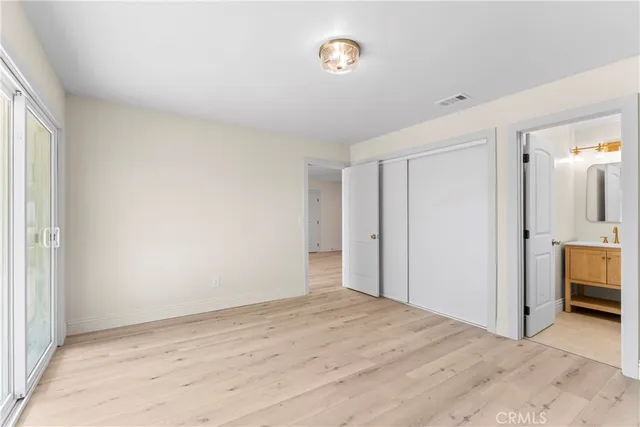 a view of empty room with kitchen view