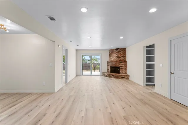 wooden floor in an empty room with a fireplace