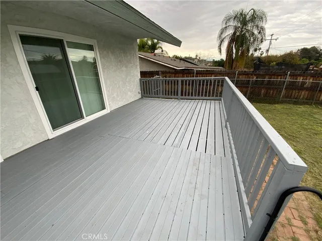 a view of balcony with a large window and wooden floor