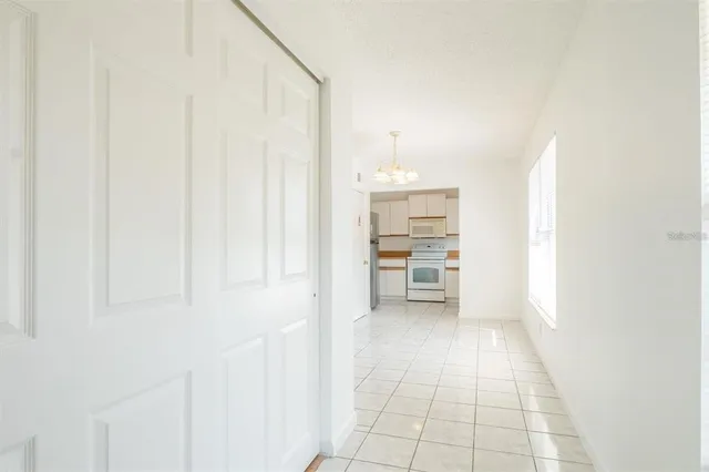 a view of a kitchen with furniture and an empty room