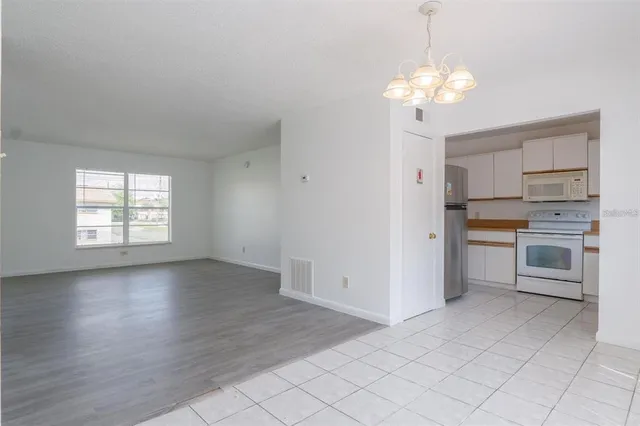a view of a kitchen with a sink a stove and cabinets