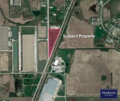 an aerial view of a residential building with an outdoor space