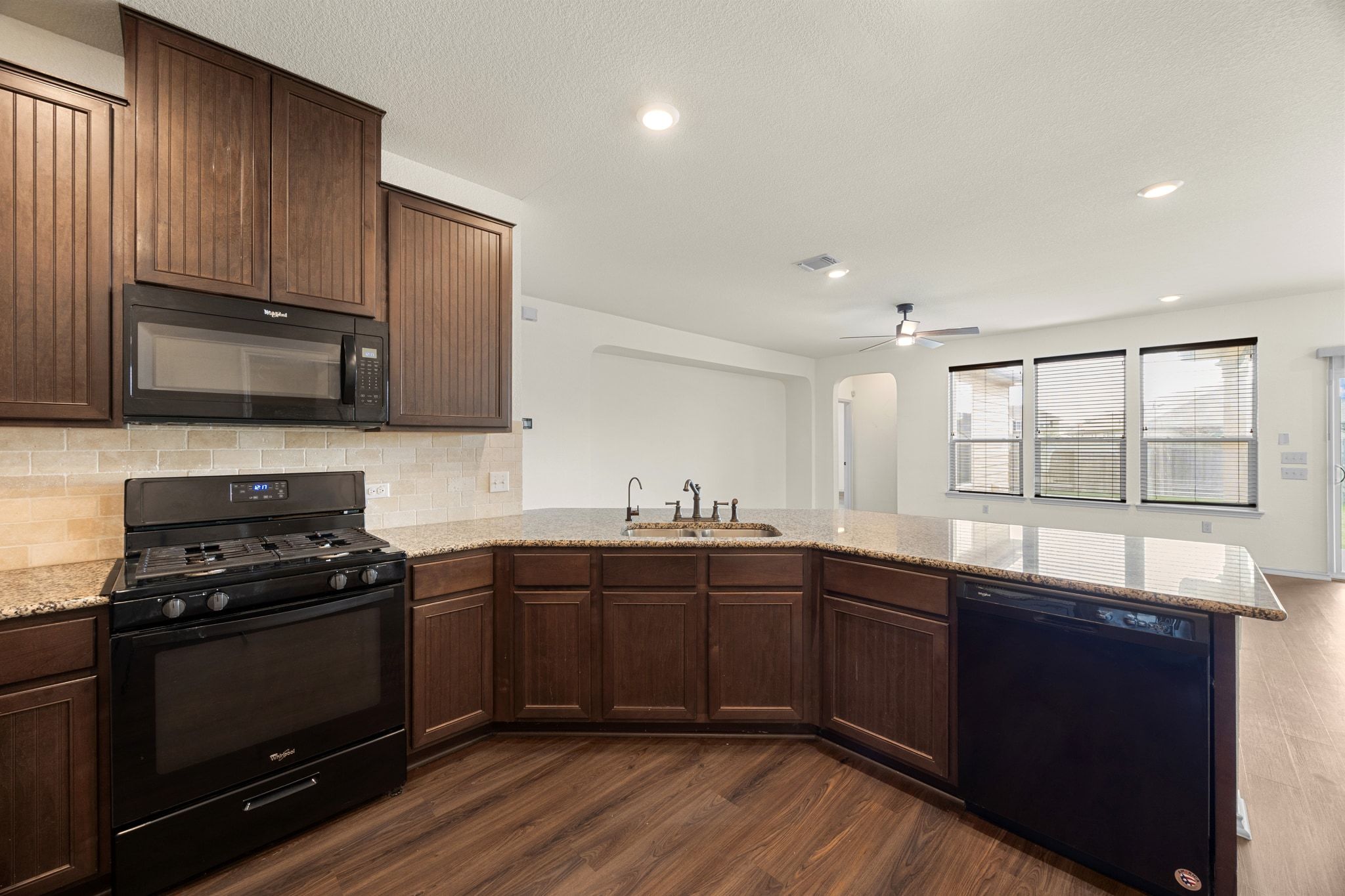 136 Vickers Street Georgetown, TX 78628 - Photo 12 of 33 a kitchen with stainless steel appliances a stove sink and cabinets