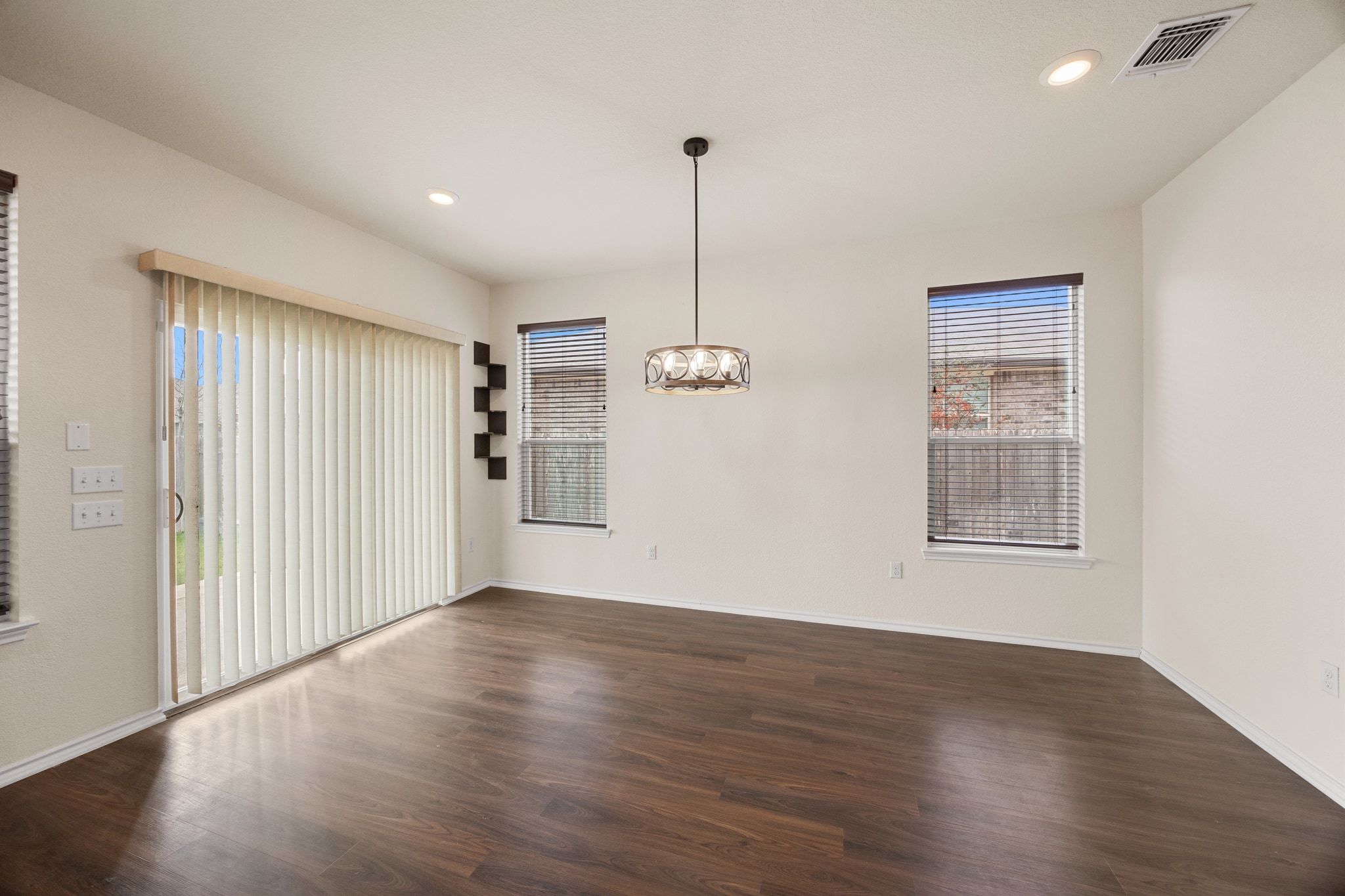 136 Vickers Street Georgetown, TX 78628 - Photo 13 of 33 a view of an empty room with wooden floor and a window