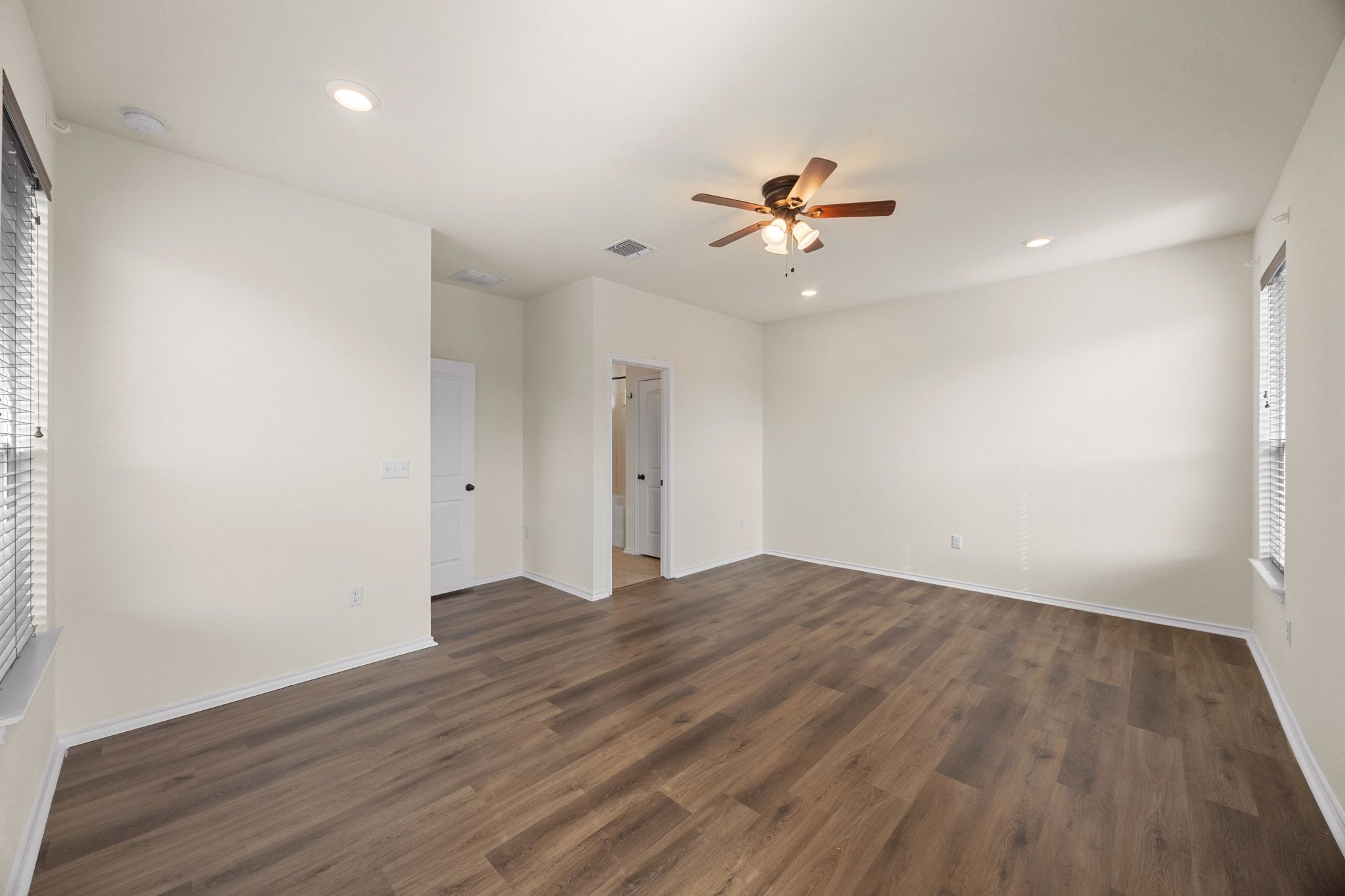 136 Vickers Street Georgetown, TX 78628 - Photo 16 of 33 an empty room with wooden floor ceiling fan and window